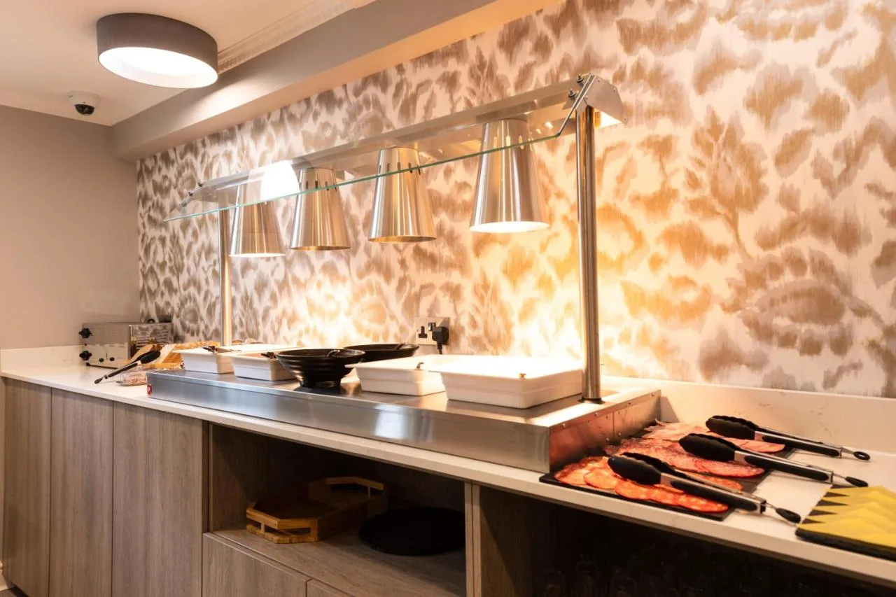 a kitchen with a counter with some food on it at Byron Hotel in London