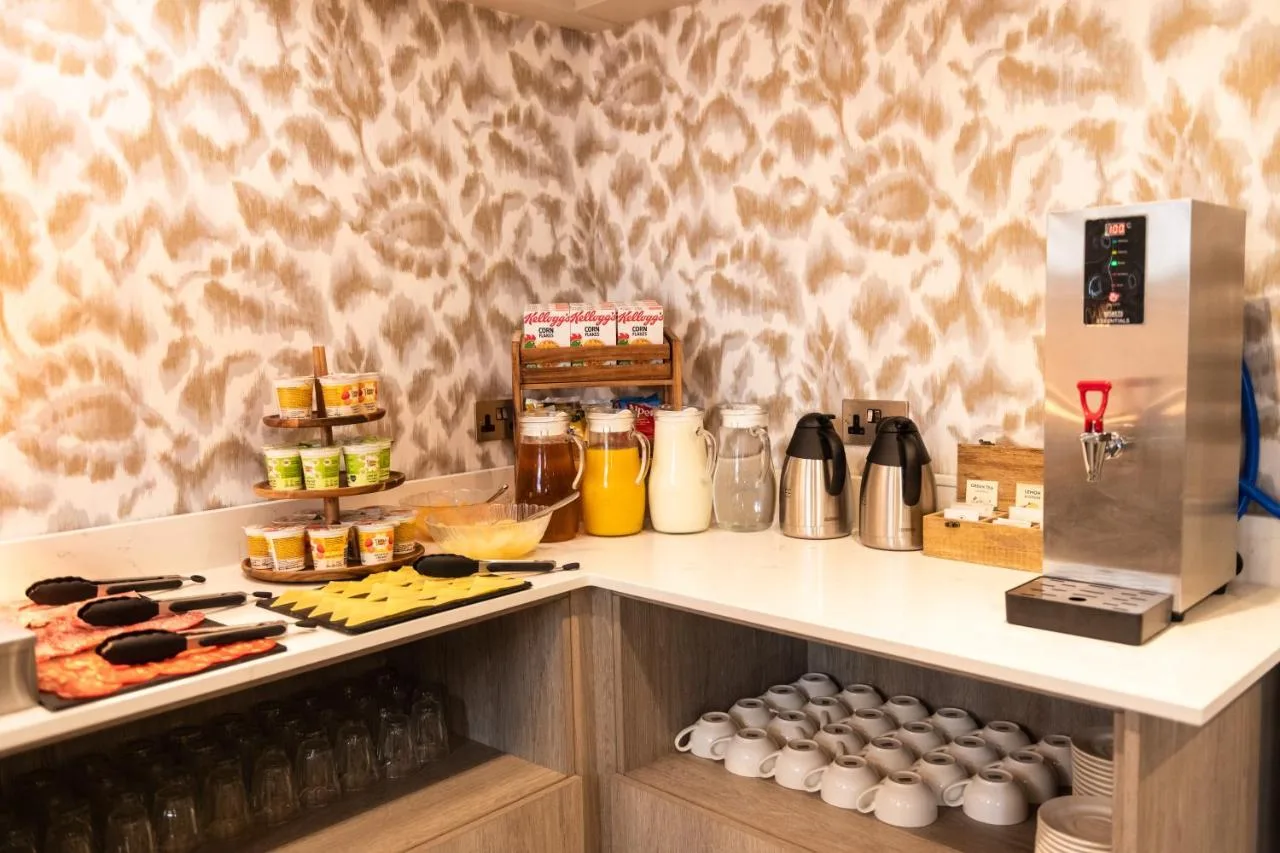 a kitchen with a counter with food on it at Byron Hotel in London