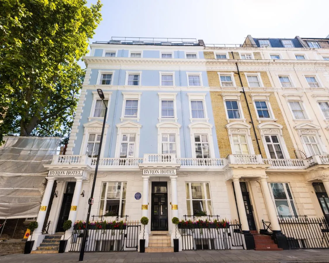 a white building with a fence in front of it at Byron Hotel in London