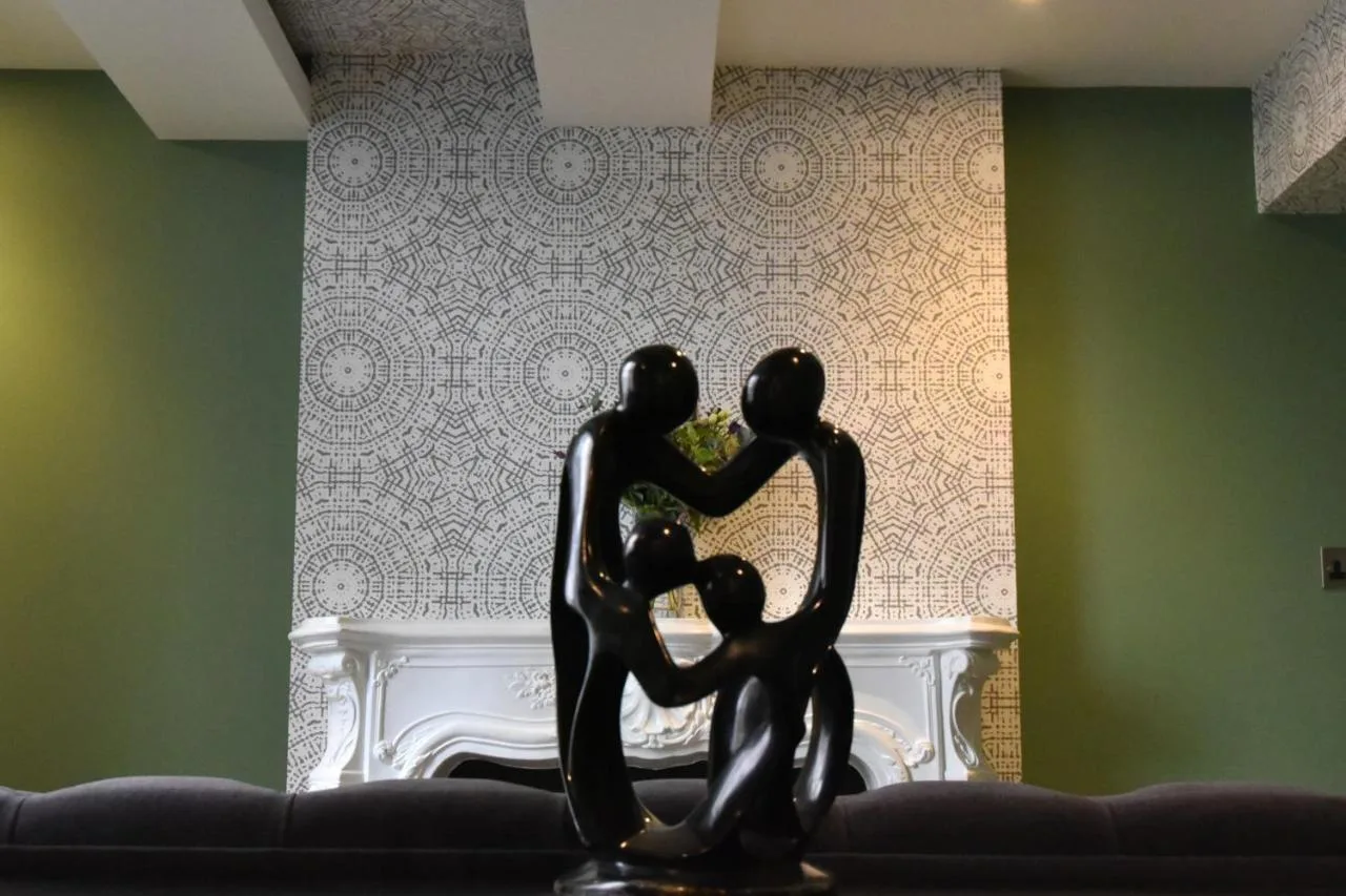 a statue of a family sitting on a couch at Byron Hotel in London
